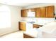 Bright kitchen with white appliances, white countertops, and classic wood cabinetry at 631 Natalie Dr, Graham, NC 27253
