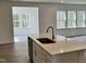 Bright kitchen featuring white cabinets, stainless appliances, and a center island at 660 Sun Meadow Dr, Wake Forest, NC 27587