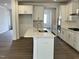 Bright kitchen featuring white cabinets, stainless appliances, and a center island at 660 Sun Meadow Dr, Wake Forest, NC 27587