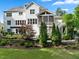 Back exterior view of a two-story home with screened porch, patio, and landscaped yard at 6829 Palaver Ln, Cary, NC 27519
