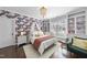Charming bedroom featuring floral wallpaper, decorative chandelier, and a cozy window seat at 6829 Palaver Ln, Cary, NC 27519