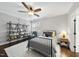 Bedroom with neutral walls, wooden floors, and an elegant metal frame bed, bathed in natural light at 6829 Palaver Ln, Cary, NC 27519