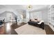 Bright bonus room with natural light, a comfortable sofa, and built-in shelves at 6829 Palaver Ln, Cary, NC 27519