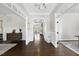 Inviting foyer with dark hardwood floors and elegant trim details, leading to other living spaces at 6829 Palaver Ln, Cary, NC 27519