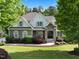 Charming two-story home featuring stone accents, lush landscaping, and a well-manicured lawn at 6829 Palaver Ln, Cary, NC 27519