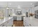Beautiful kitchen with dual islands, farmhouse sink, stainless appliances, and backyard view at 6829 Palaver Ln, Cary, NC 27519