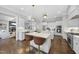 Bright, open kitchen with white cabinetry, marble countertops, and stainless steel appliances at 6829 Palaver Ln, Cary, NC 27519