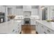 Expansive kitchen islands with quartz countertops, brass hardware, and a stainless steel range at 6829 Palaver Ln, Cary, NC 27519