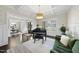 Bright living room with coffered ceilings, piano, and a large window overlooking the front yard at 6829 Palaver Ln, Cary, NC 27519