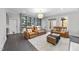 Cozy living room with leather recliners, built-in bookshelves, and access to the backyard at 6829 Palaver Ln, Cary, NC 27519