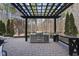 Outdoor kitchen with a built-in grill, countertop, and pergola, creating a perfect space for outdoor entertaining at 6829 Palaver Ln, Cary, NC 27519