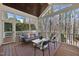 Inviting screened porch with comfortable seating, offering a serene outdoor living space with wooded views at 6829 Palaver Ln, Cary, NC 27519