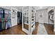 Large walk-in closet with shoe racks, shelving, and hanging storage on hardwood floors at 6829 Palaver Ln, Cary, NC 27519