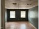 Bedroom features paneled ceiling, laminate floors, and two windows at 731 Latimer St, Hillsborough, NC 27278