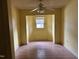 Empty yellow bedroom with single window and ceiling fan at 731 Latimer St, Hillsborough, NC 27278