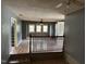Spacious living room featuring hardwood floors, three windows, and a ceiling fan at 731 Latimer St, Hillsborough, NC 27278