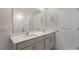 Bathroom featuring double sinks, a large mirror, and a glass-door shower at 83 Paper Birch Way, Fuquay Varina, NC 27526