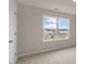 Bedroom with a large window overlooking the community and neighborhood at 83 Paper Birch Way, Fuquay Varina, NC 27526