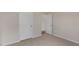 Bedroom featuring neutral carpet, white trim and paneled doors at 83 Paper Birch Way, Fuquay Varina, NC 27526