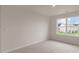 Bright, carpeted bedroom with a large window at 83 Paper Birch Way, Fuquay Varina, NC 27526
