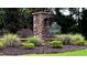 Welcome to Woodgrove community entrance with stone signage and landscaping at 83 Paper Birch Way, Fuquay Varina, NC 27526