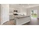 Bright kitchen showcasing stainless steel appliances, a spacious island, and light-colored cabinetry at 83 Paper Birch Way, Fuquay Varina, NC 27526