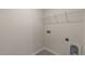 Practical laundry room with wire shelving and connections for appliances at 83 Paper Birch Way, Fuquay Varina, NC 27526