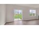 Bright living room featuring hardwood floors, sliding glass door, and a large window at 83 Paper Birch Way, Fuquay Varina, NC 27526