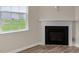 Close up of fireplace with white molding and view from window at 83 Paper Birch Way, Fuquay Varina, NC 27526