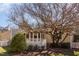 Back exterior showcasing the screened in porch at 8940 Wildwood Links, Raleigh, NC 27613