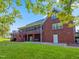Rear exterior of a brick home featuring a screened-in porch, landscaped yard, and a cozy swing underneath at 93 Shoreline Dr, Princeton, NC 27569