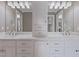 Bright bathroom featuring a double vanity with white marble countertop and decorative lighting at 93 Shoreline Dr, Princeton, NC 27569
