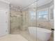 Bathroom showcases a free-standing tub and a glass shower with marble-look tile surround at 93 Shoreline Dr, Princeton, NC 27569