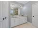 Bathroom features a double sink vanity with marble countertop, white cabinets, and elegant light fixtures at 93 Shoreline Dr, Princeton, NC 27569