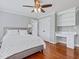 Bedroom featuring hardwood floors, a ceiling fan, and a built-in desk, creating a functional space at 93 Shoreline Dr, Princeton, NC 27569
