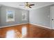 Traditional bedroom with hardwood floors, two windows, and a ceiling fan at 93 Shoreline Dr, Princeton, NC 27569