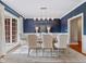 Elegant dining room with white chairs, hardwood floors, and large window at 93 Shoreline Dr, Princeton, NC 27569