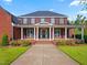 Charming brick home with a covered porch, white columns, and meticulous landscaping provides picturesque curb appeal at 93 Shoreline Dr, Princeton, NC 27569