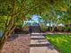 Landscaped front yard with a stone pathway leading to brick stairs and lush green grass at 93 Shoreline Dr, Princeton, NC 27569