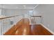 Upstairs hallway with hardwood floors, white railings, and natural light at 93 Shoreline Dr, Princeton, NC 27569