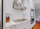 Modern kitchen includes a cooktop, stainless hood, and double ovens at 93 Shoreline Dr, Princeton, NC 27569