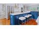 Kitchen features a blue island with white countertop and stainless steel appliances at 93 Shoreline Dr, Princeton, NC 27569