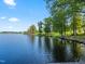 Picturesque lakeside view with boats, lush trees and clear skies at 93 Shoreline Dr, Princeton, NC 27569