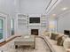 Bright living room featuring a fireplace with built-in shelves and large center table at 93 Shoreline Dr, Princeton, NC 27569