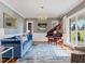 Bright living room with a grand piano, large windows, and stylish decor at 93 Shoreline Dr, Princeton, NC 27569