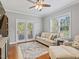 Comfortable living room with hardwood floors, ceiling fan, and french doors to a deck at 93 Shoreline Dr, Princeton, NC 27569