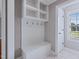 Mudroom featuring built-in storage, including a bench, hooks, and shelving for organized entry at 93 Shoreline Dr, Princeton, NC 27569
