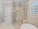 A luxurious shower with marble tile, a rain shower head, and built-in seating at 93 Shoreline Dr, Princeton, NC 27569