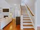 A staircase with wooden handrails ascends from the main level at 93 Shoreline Dr, Princeton, NC 27569