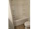 Clean bathroom featuring a bathtub and shower combo with stylish wood flooring at 104 Lavender Ln, Clayton, NC 27520